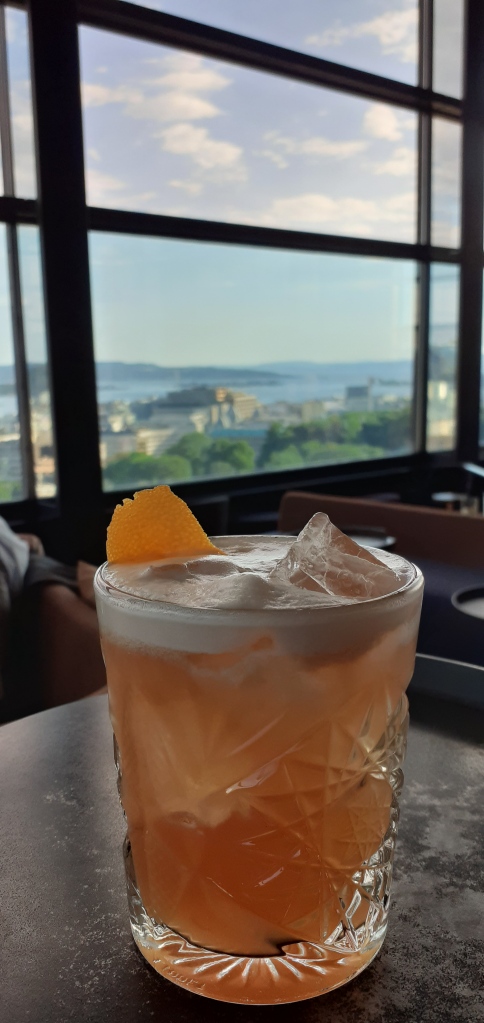 Cocktail in front of a window looking out onto Oslo Fjord